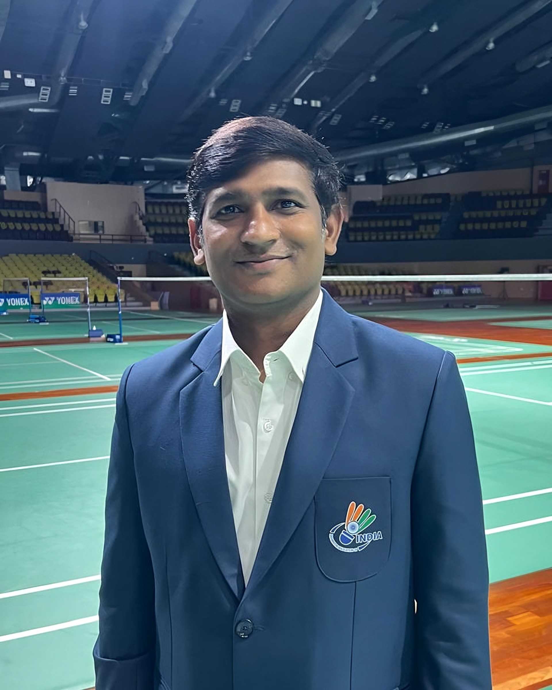 Lomada Raju in his India blazer at a badminton arena