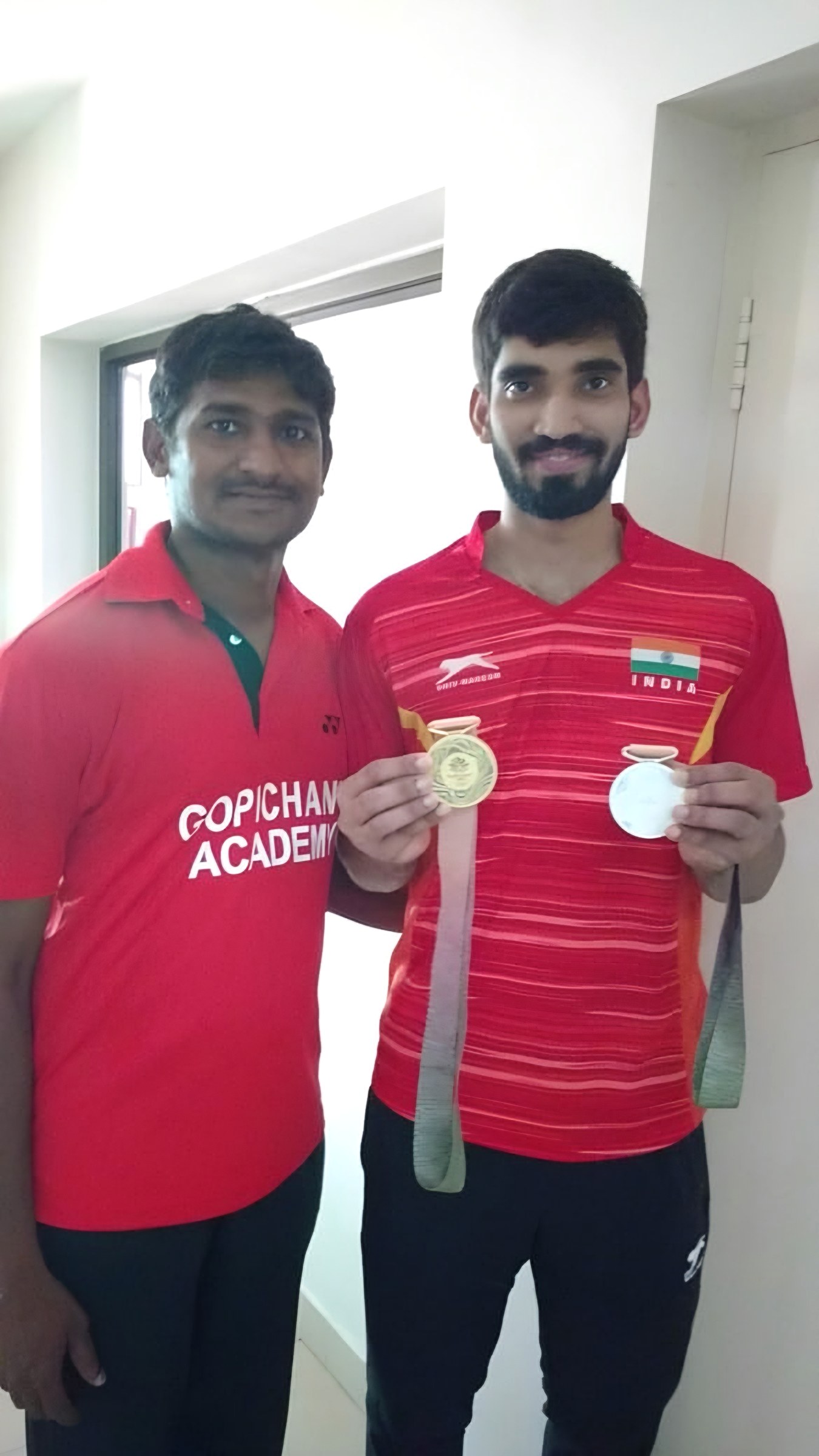 Two young athletes holding their medals